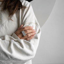 Load image into Gallery viewer, A woman wears ARK ring while she shows an artwork on the wall