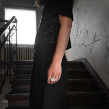 Load image into Gallery viewer, Street style photo shooting of a woman with a black and glamour outfit in an urban Berliner building