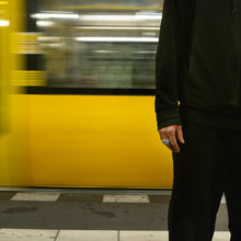 Load image into Gallery viewer, a man wears ARK while he waiting the U-Bahn train