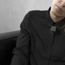 Load image into Gallery viewer, A woman with a blond hair wearing the White Cube Necklace with a black bluse on a grey background