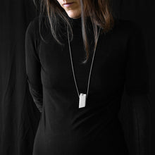 Load image into Gallery viewer, a woman while are wearing blocco 55 in a black background 
