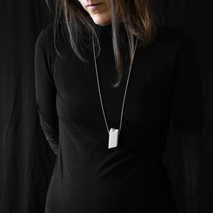 a woman while are wearing blocco 55 in a black background 