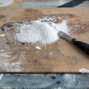 Carrara marble powder on a wood table
