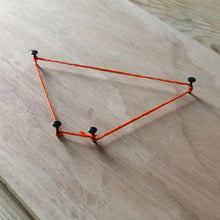 Load image into Gallery viewer, The Asteroid project, with four nails and an orange string on on a wooden board