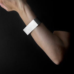 woman arm that are wearing MOON bracelet in silver 925 with black background 