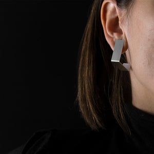 woman are wearing Silver Square Earrings with black background