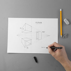The design on paper of the FUTURA necklaces' project with a hand that draws, eraser and sharpener.