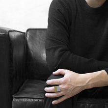 Load image into Gallery viewer, man wearing the Assembled ring, a combination of Aluminium square ring and brass square ring, seat on black sofa